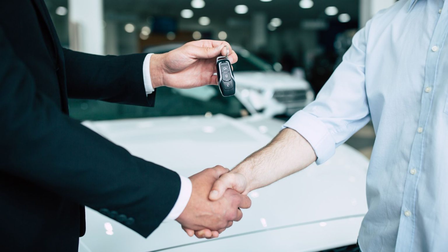 dealer handing over car keys